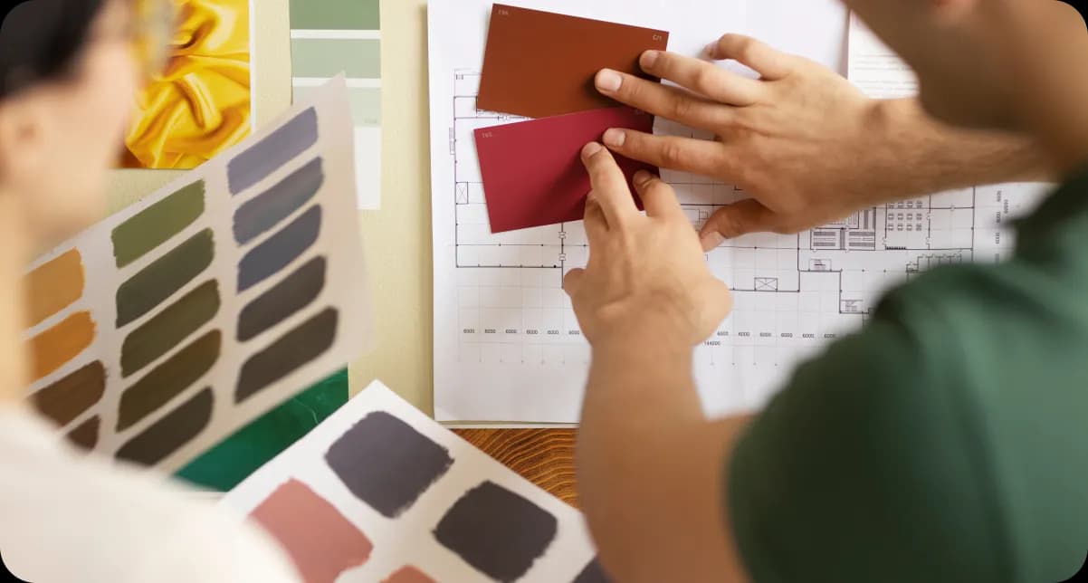 Creative team reviewing color swatches and blueprints together